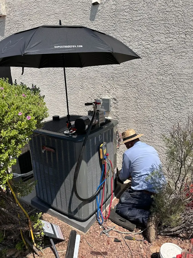 HVAC technician performing outdoor AC maintenance in Rigby